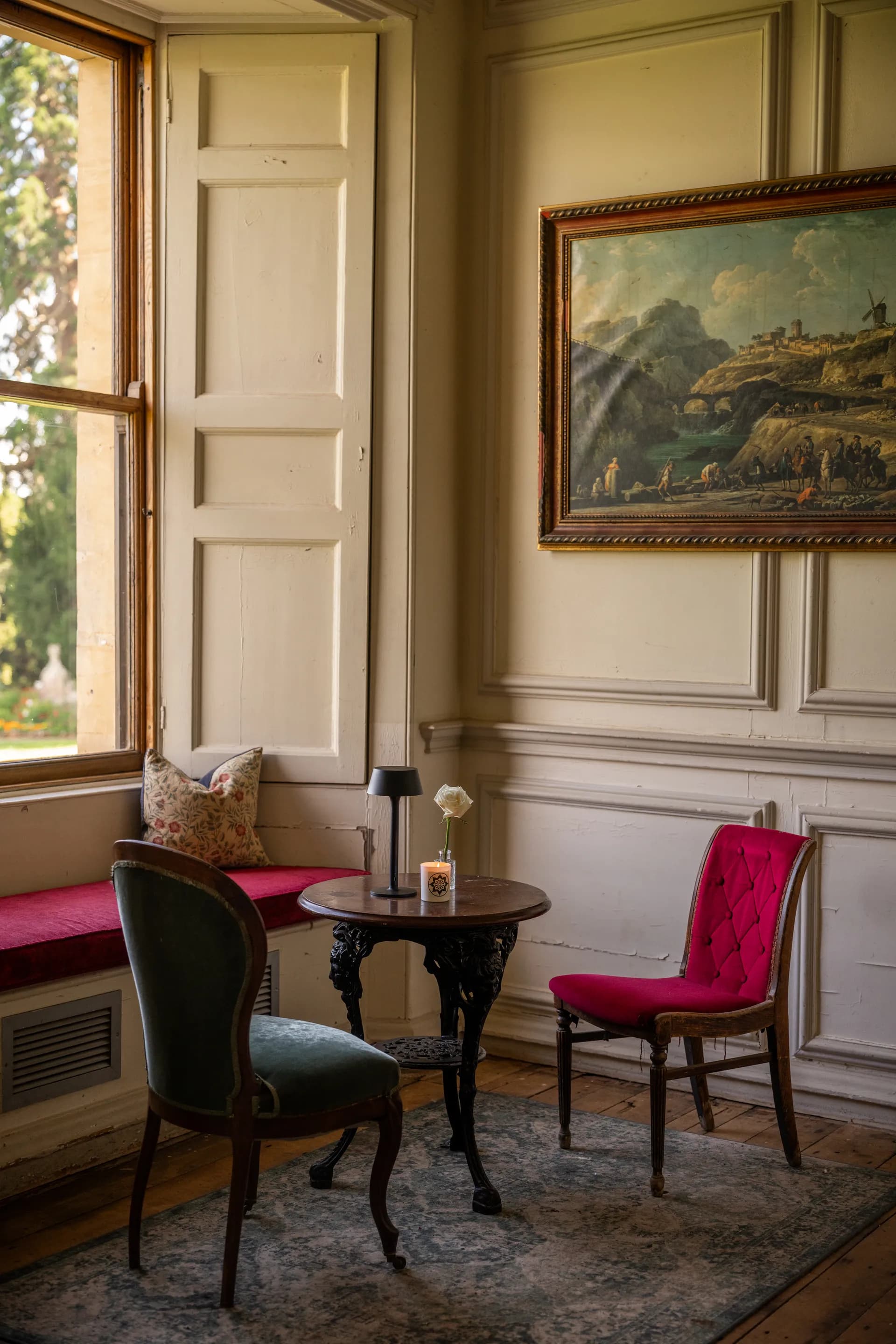 The Lounge with velvet chairs and a painting